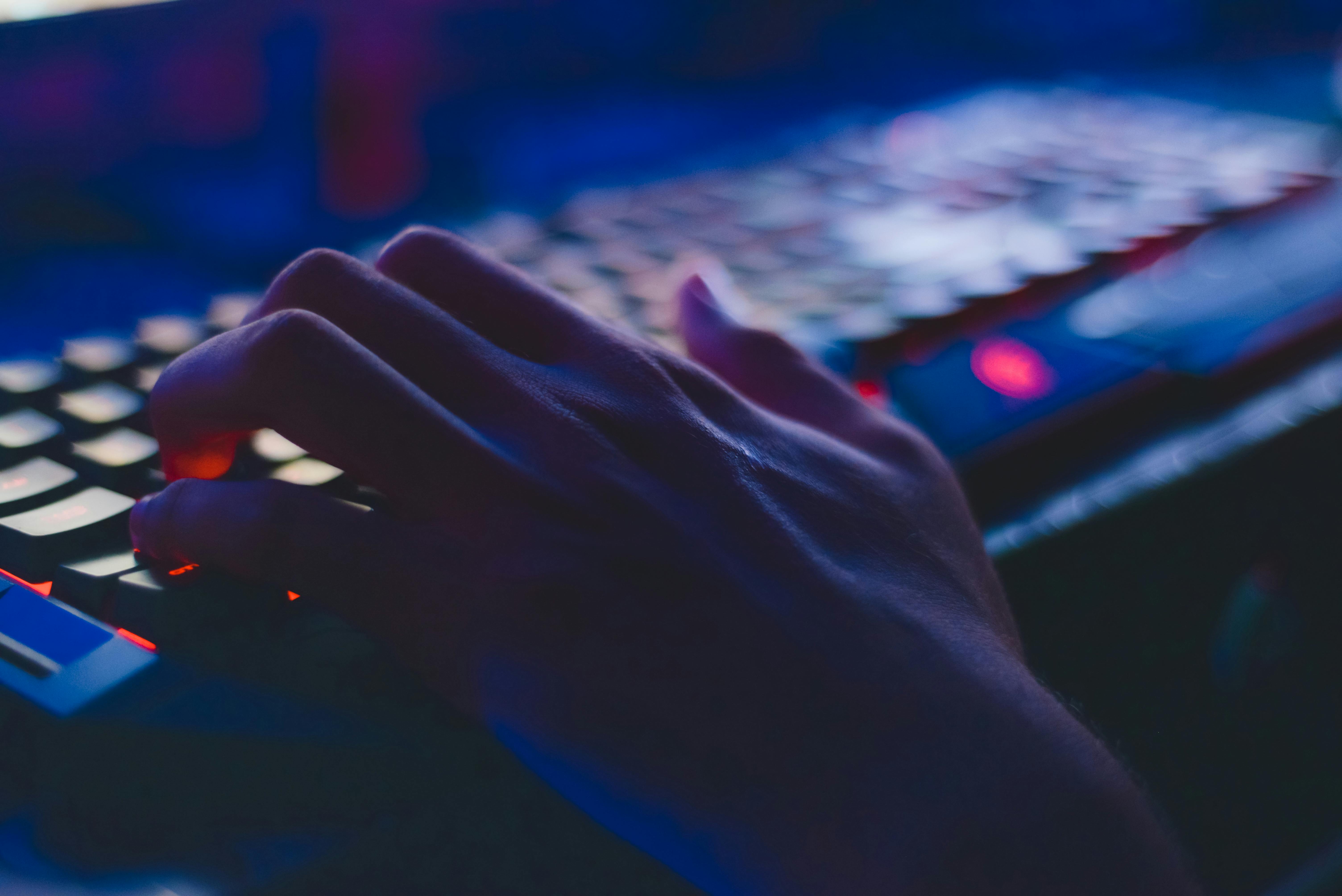 Hand on LED glowing keyboard