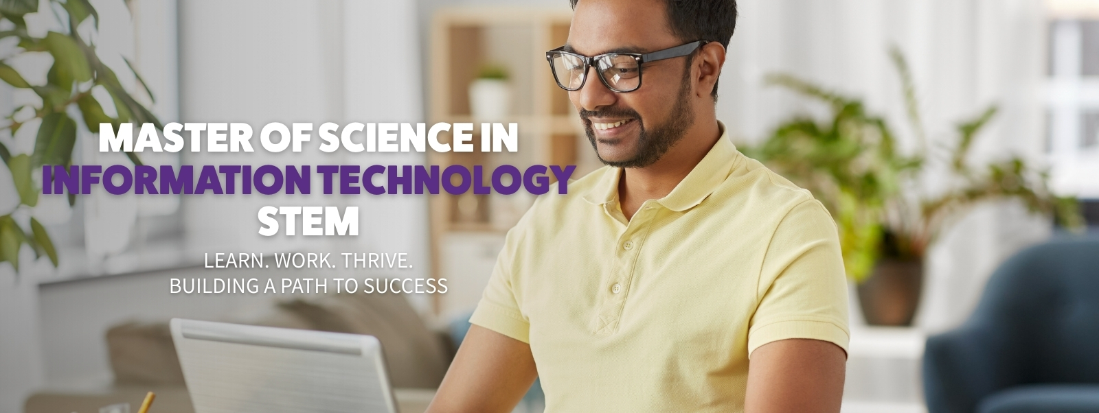 student with headphones working on laptop