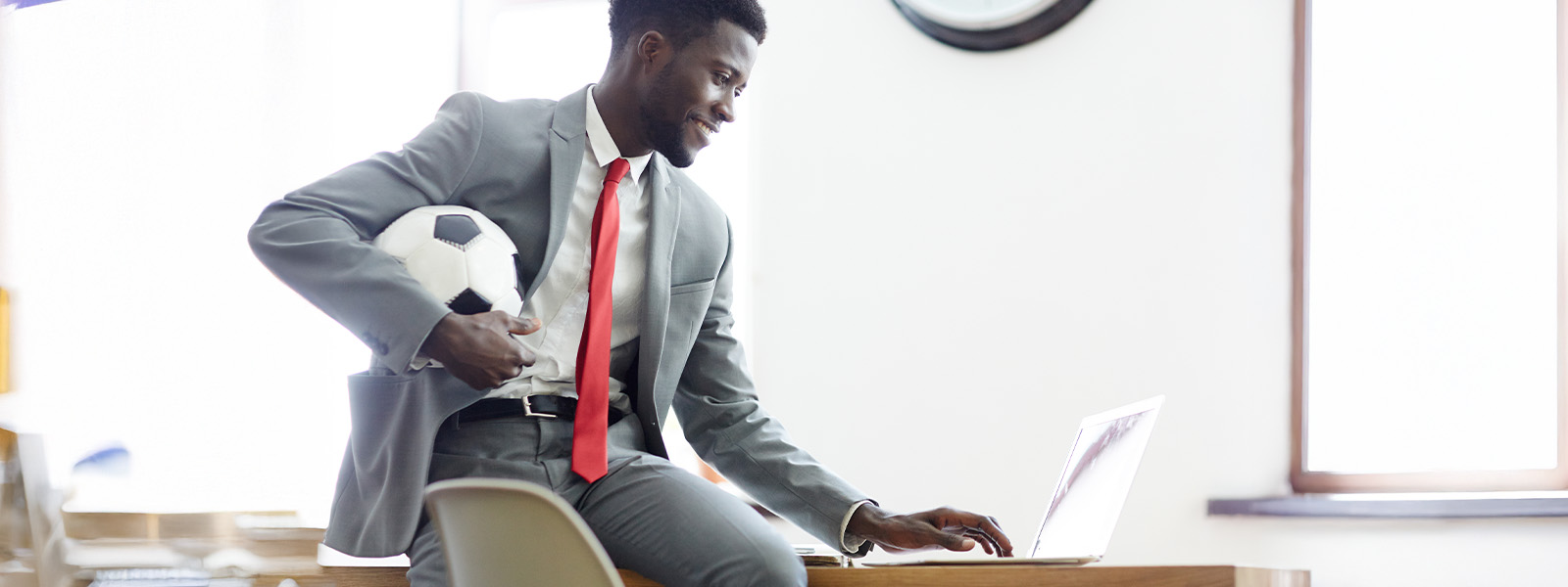 business man working and holding a soccer ball